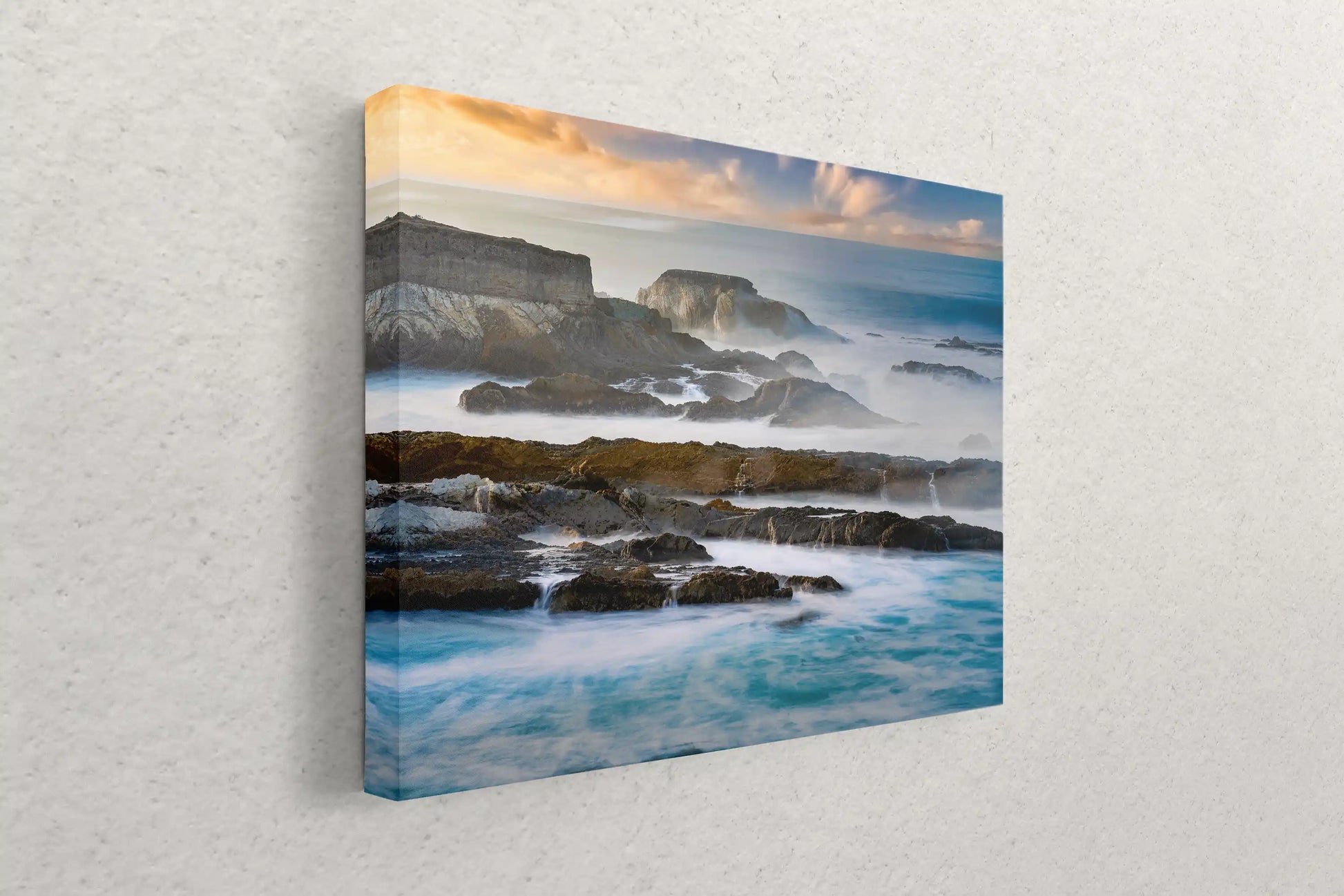 Side view of a canvas wall art featuring the dynamic California Pacific Seascape with waves crashing against rugged cliffs.
