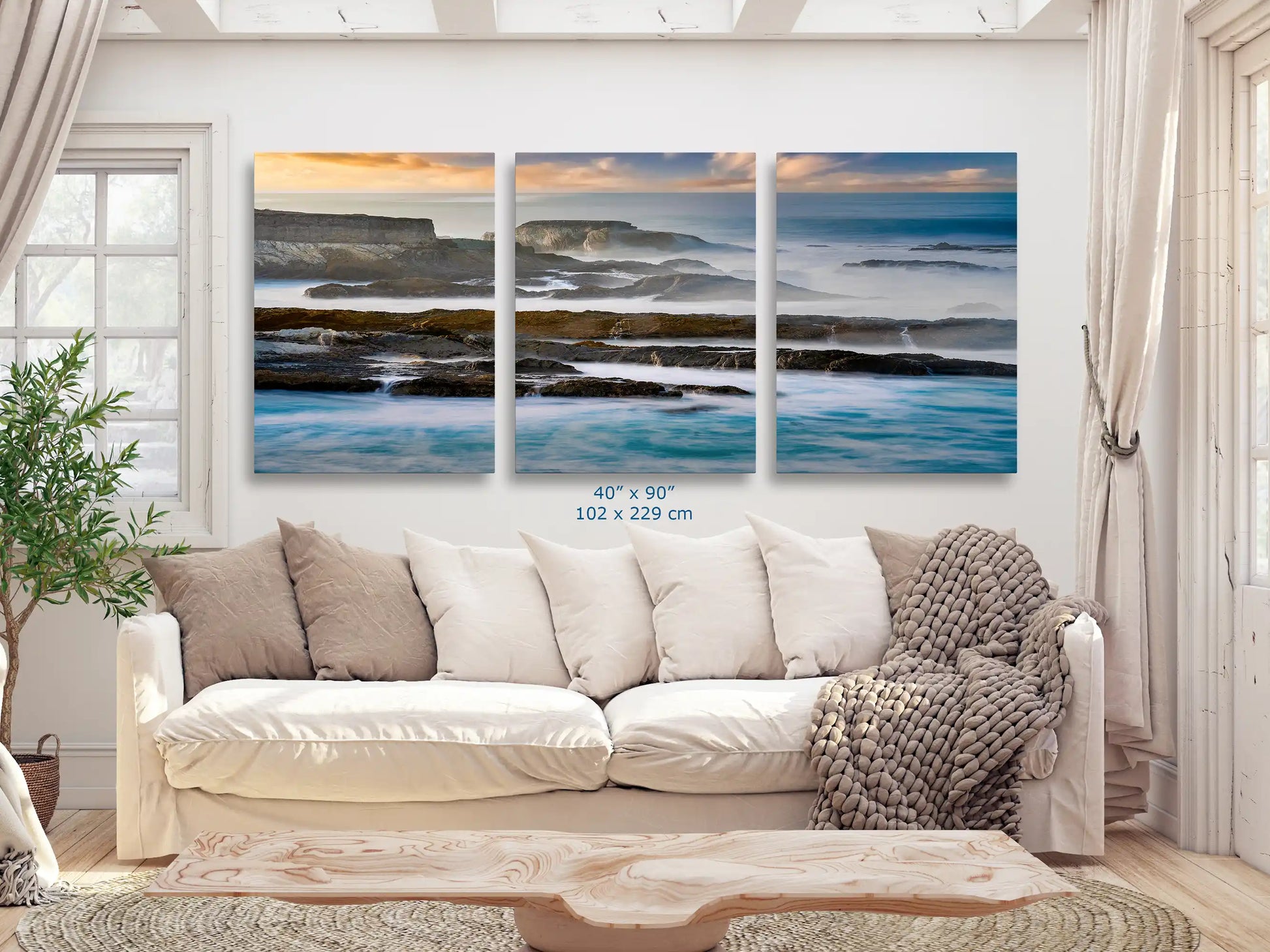 Massive 40x90 inch wall art spanning over a sofa, presenting an immersive view of the California Pacific cliffs and waves, making a grand statement.