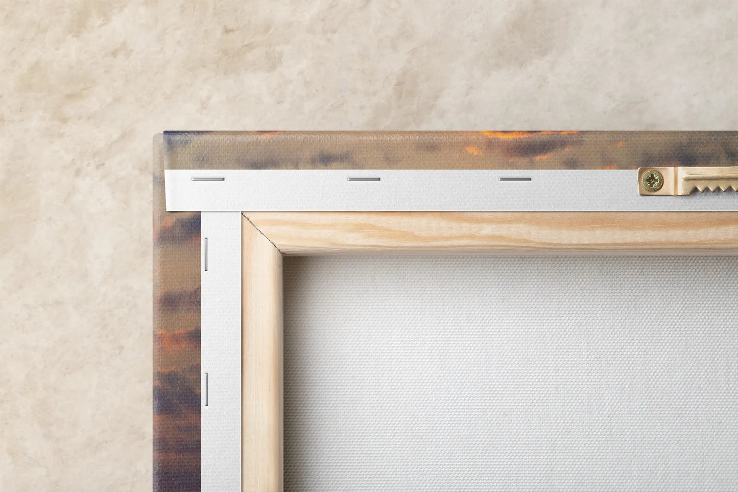 Close-up view of the back of a canvas print showing the sturdy wooden frame and metal mounting hardware against a textured backdrop.