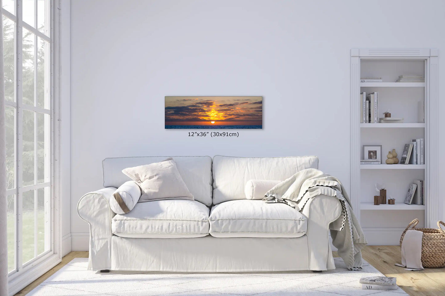 Cozy living room with a 12x36 inch canvas print of an ocean sunset, complementing the tranquil ambiance.