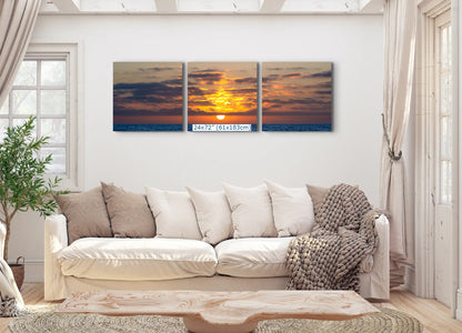 Elegant living room decorated with a panoramic 24x72 inch canvas print of a breathtaking ocean sunset.