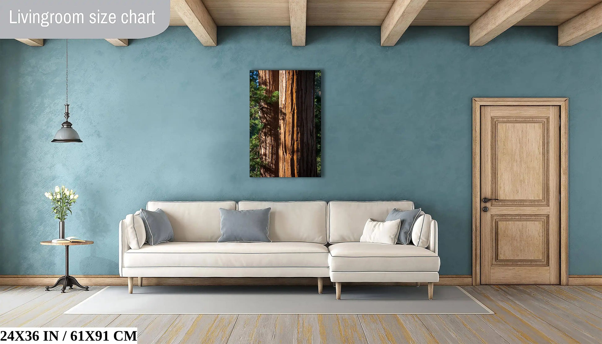 A 24"x36" canvas print of a Giant Sequoia tree close-up, centered above a large couch in a living room with teal walls and wooden flooring.