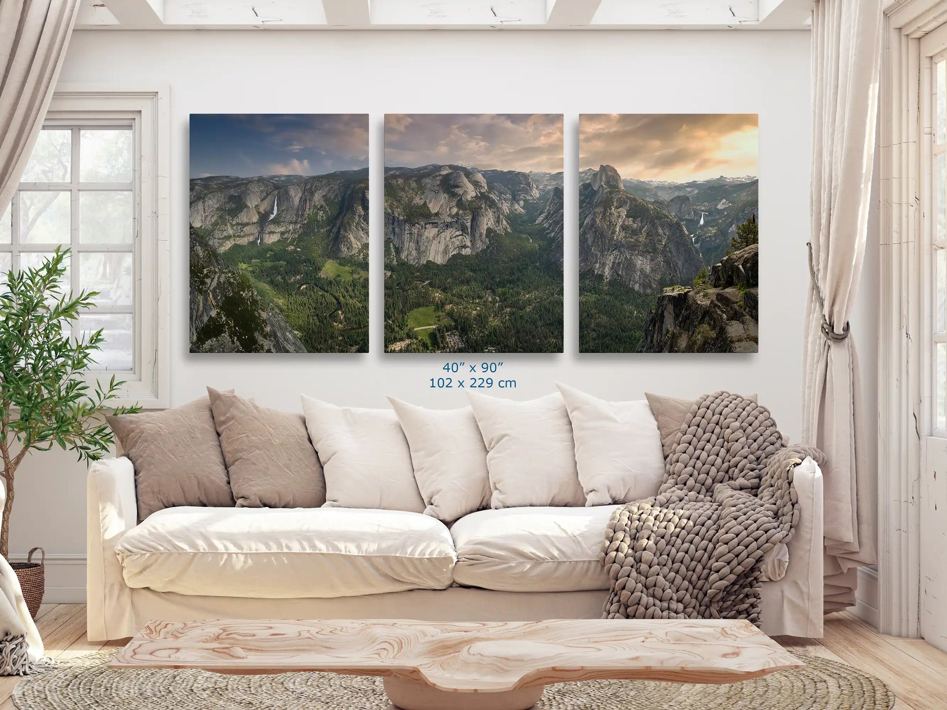 Massive 40x90 inch triptych print of Yosemite Valley from Glacier Point displayed in a stylish living room.