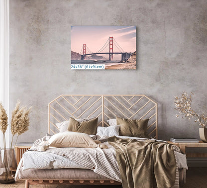 A 24x36 canvas print of the Golden Gate Bridge in vintage tones, placed above a bed, creating a serene bedroom atmosphere.