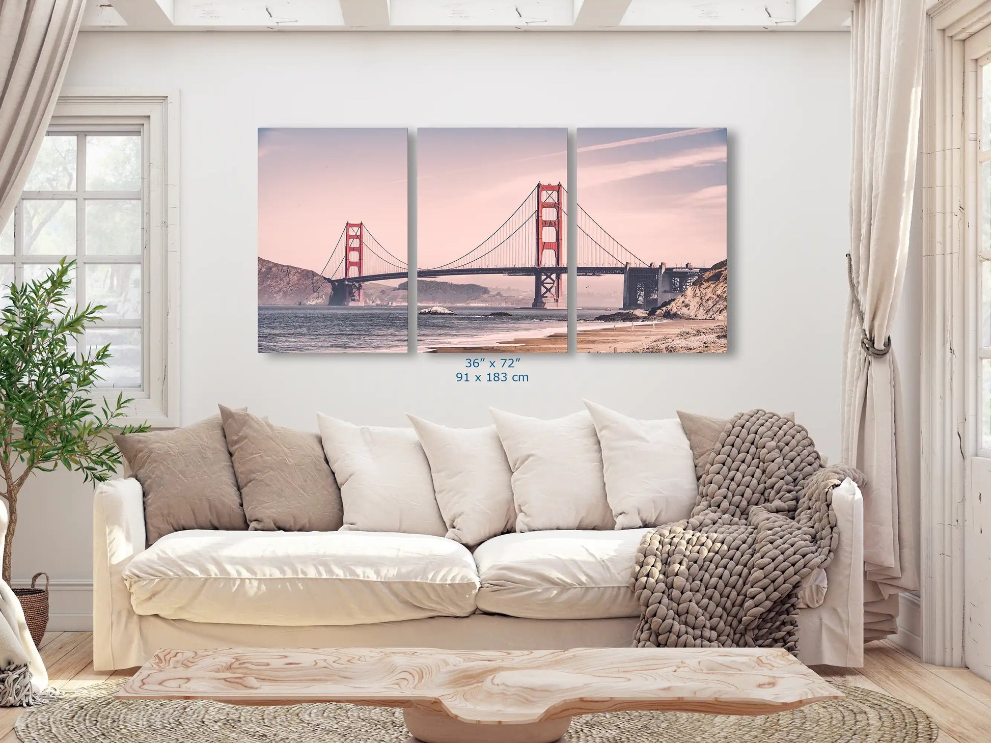 A 36x72-inch triptych canvas set displaying the Golden Gate Bridge in a vintage style, spanned across a living room wall, enhancing the space with a touch of history.