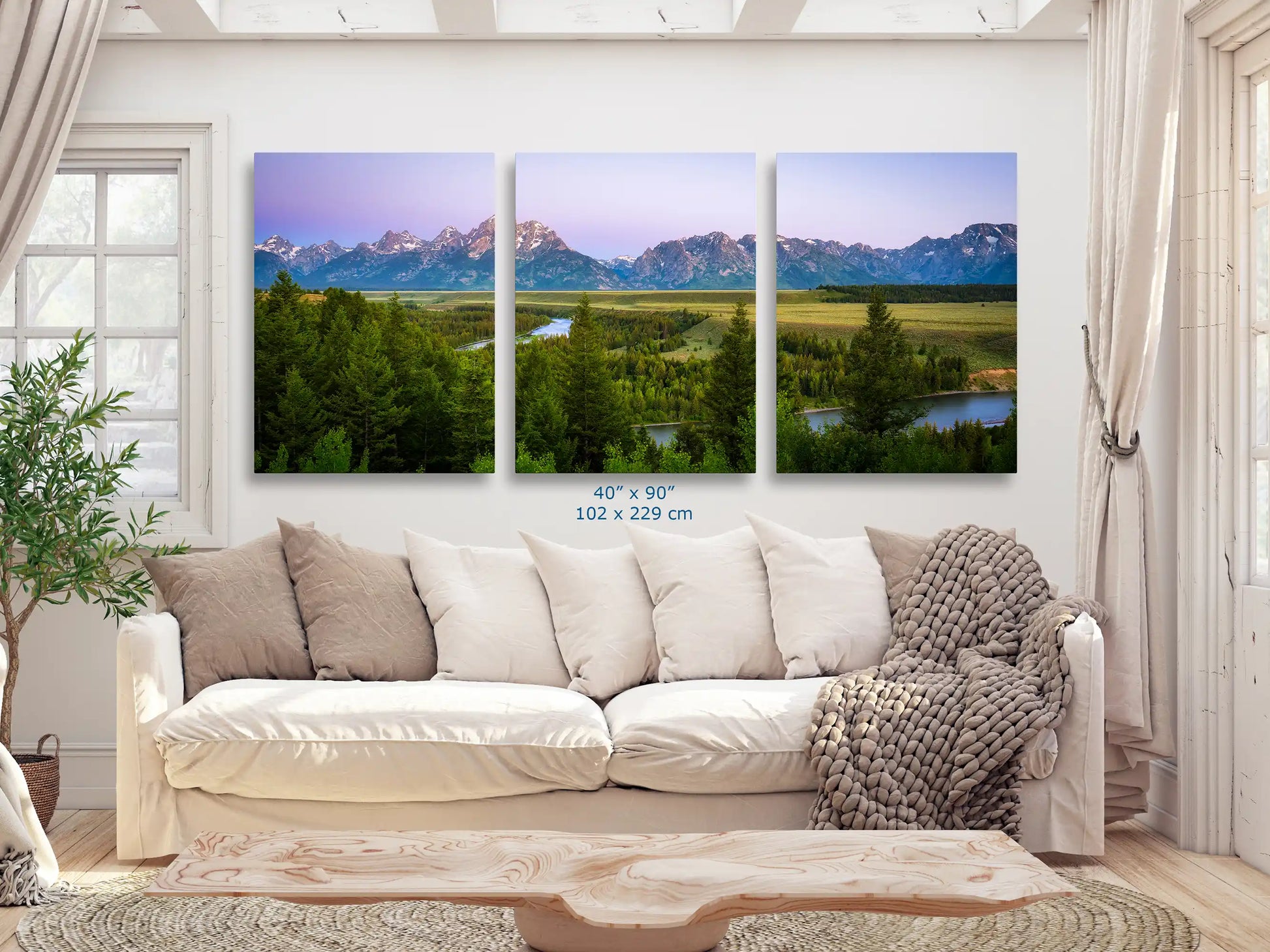 An expansive 40x90 inch canvas print of Grand Teton Mountains across the wall in a bright living space.