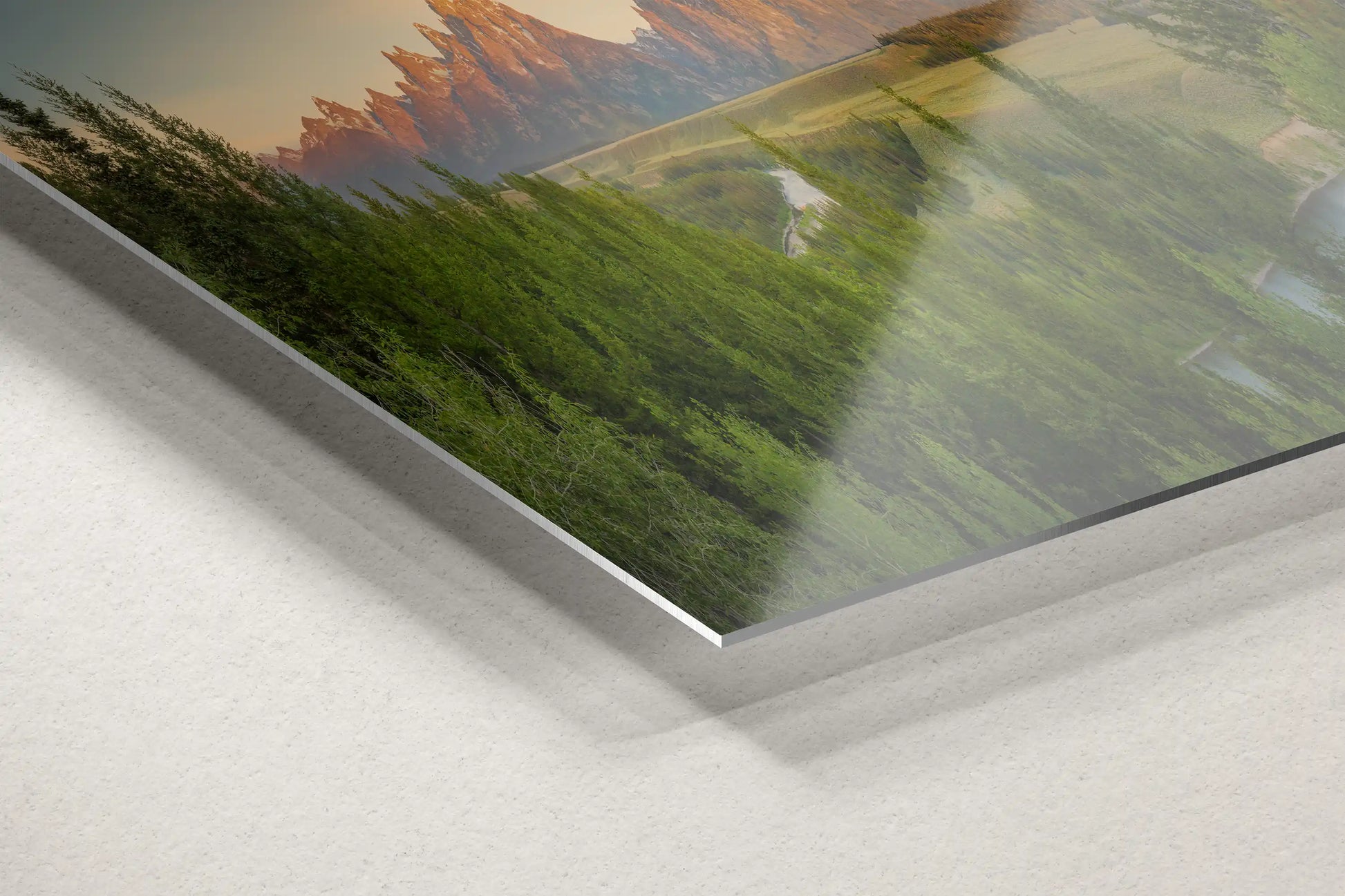 Close-up of aluminum metal corner showing a panoramic view of the Teton Mountains and Snake River at sunrise.