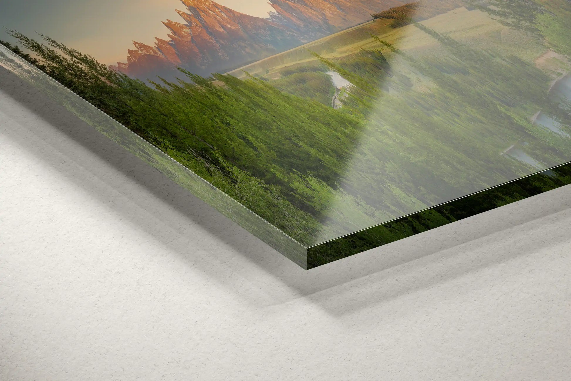 Close-up of acrylic print corner showing a panoramic view of the Teton Mountains and Snake River at sunrise.