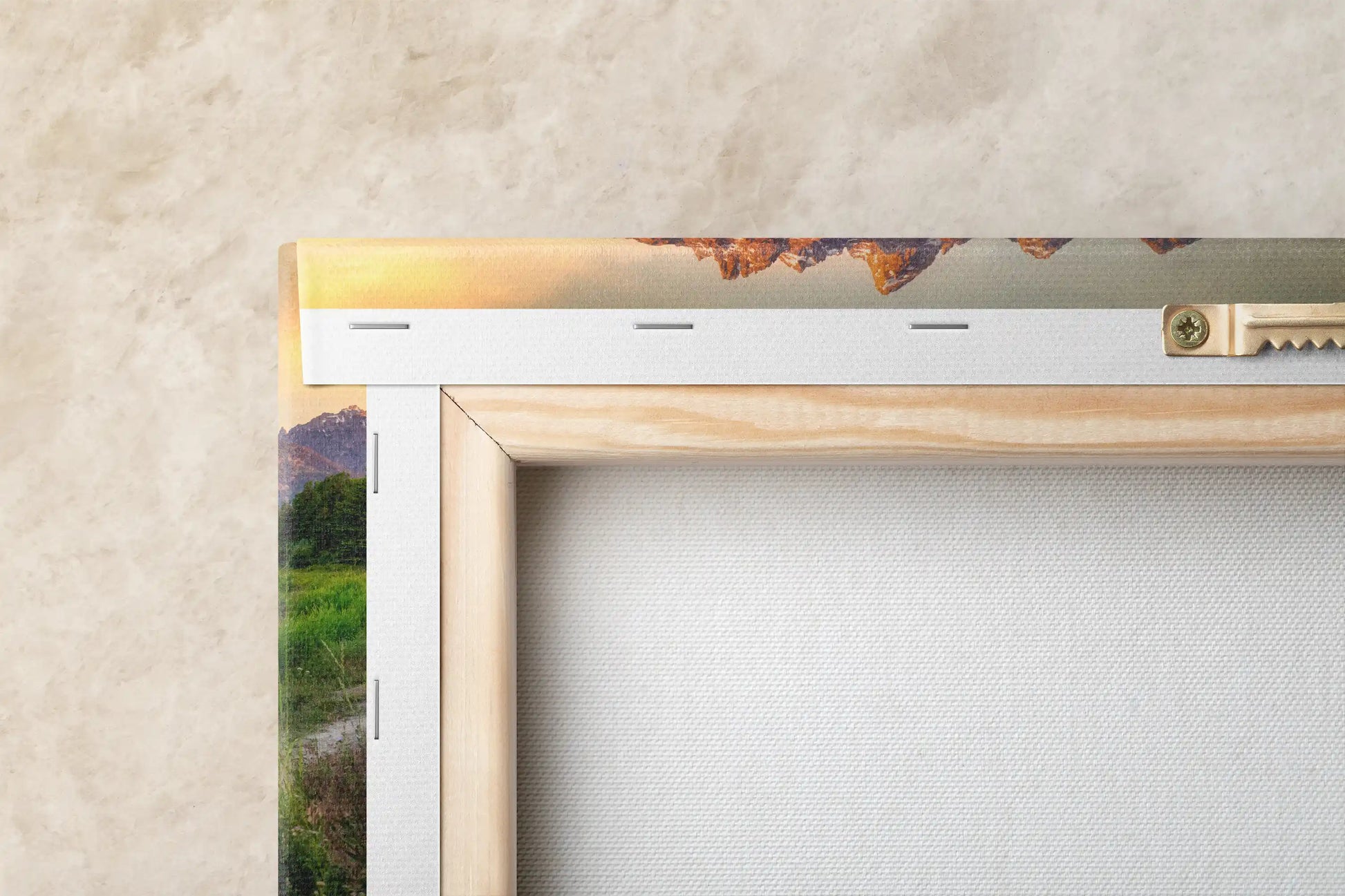Back view of a canvas print highlighting the sturdy frame and mounting hardware, with the Grand Teton Mountains at sunrise partially visible.