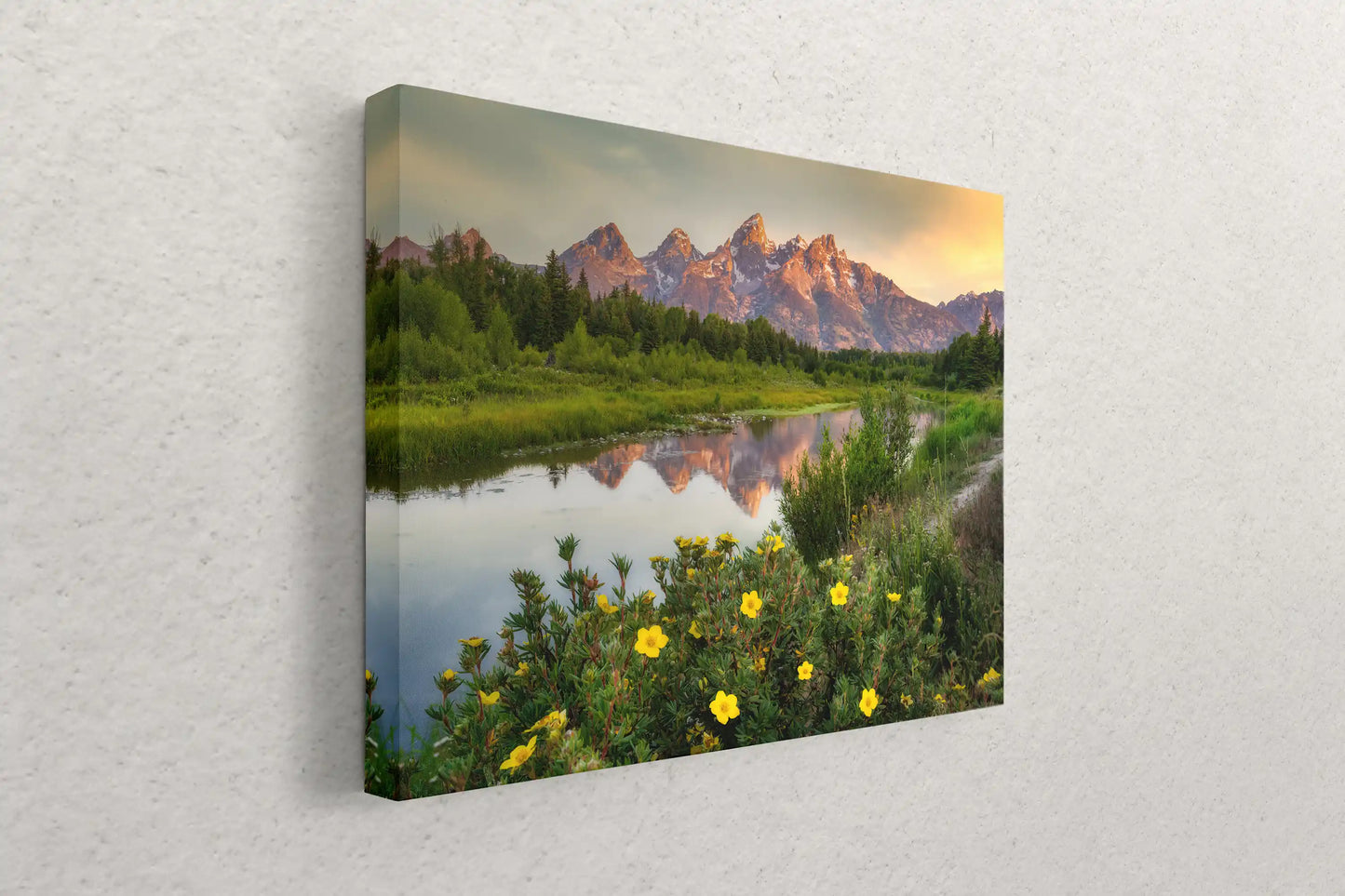 Side view of a canvas print against a white wall, showcasing the depth of the wrap and the Grand Teton Mountains at sunrise image.