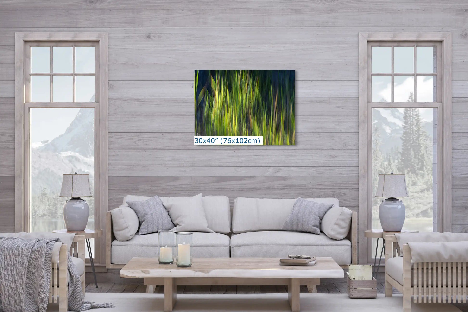A large 30"x40" canvas displaying abstract green and yellow strokes, hanging above a sofa, serves as a bold centerpiece in the spacious, naturally-lit living room.