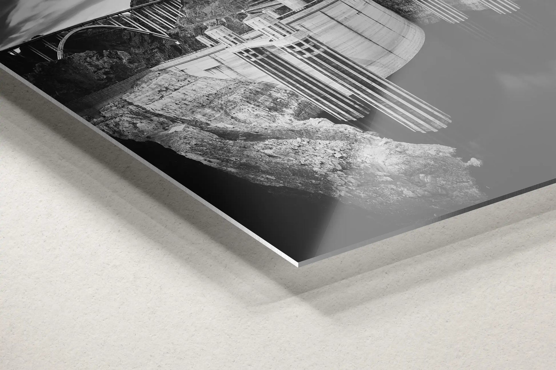 Detailed view of a metal decor piece featuring a black and white image of Hoover Dam, highlighting the sleek finish and modern aesthetic.