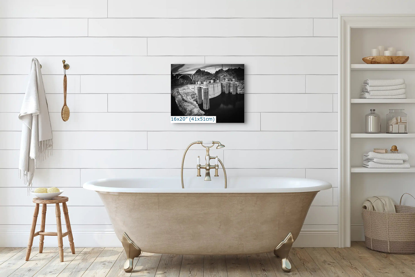 A 16x20 black and white canvas print of Hoover Dam above a bathtub, merging historical engineering with modern home decor.