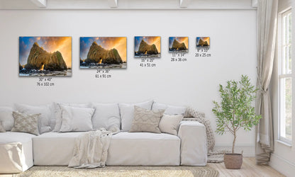 Various sizes of the Keyhole Arch canvas prints above a couch, illustrating the scale from 8"x10" to 30"x40", with a breathtaking sunset view.