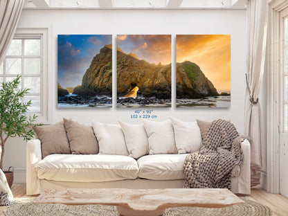 An expansive 40"x90" canvas print above a sofa, showcasing the Keyhole Arch with a sunset backdrop, making a dramatic statement in the living room.
