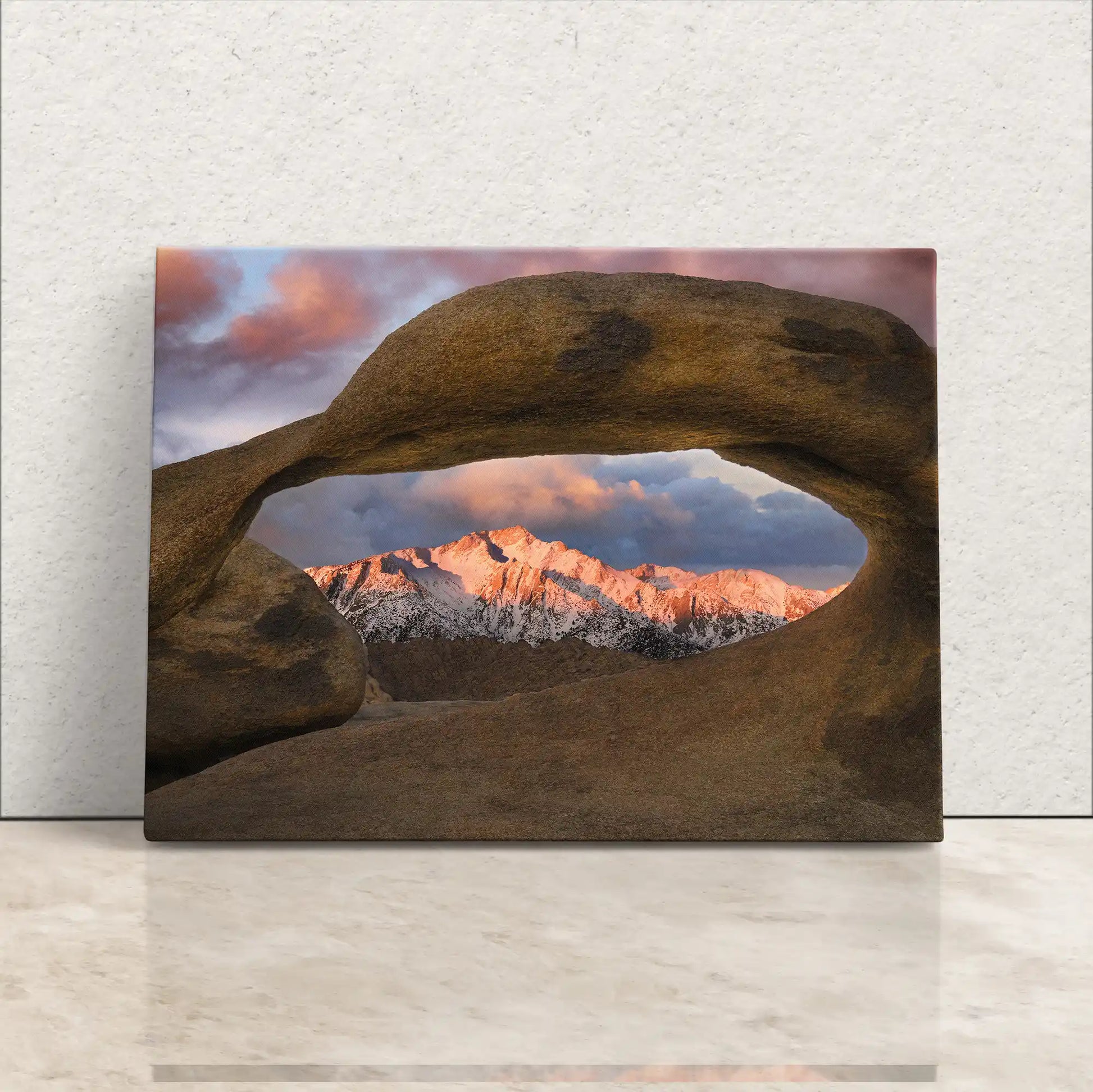 Lone Pine Peak visible through the natural window of Mobius Arch in Alabama Hills, displayed on a canvas leaning against a wall.