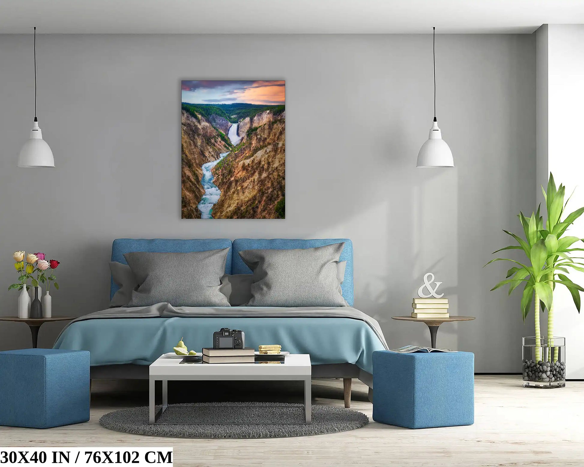 A bedroom adorned with a 30x40 inch canvas print of Lower Yellowstone Falls at sunset, offering a scenic focal point.