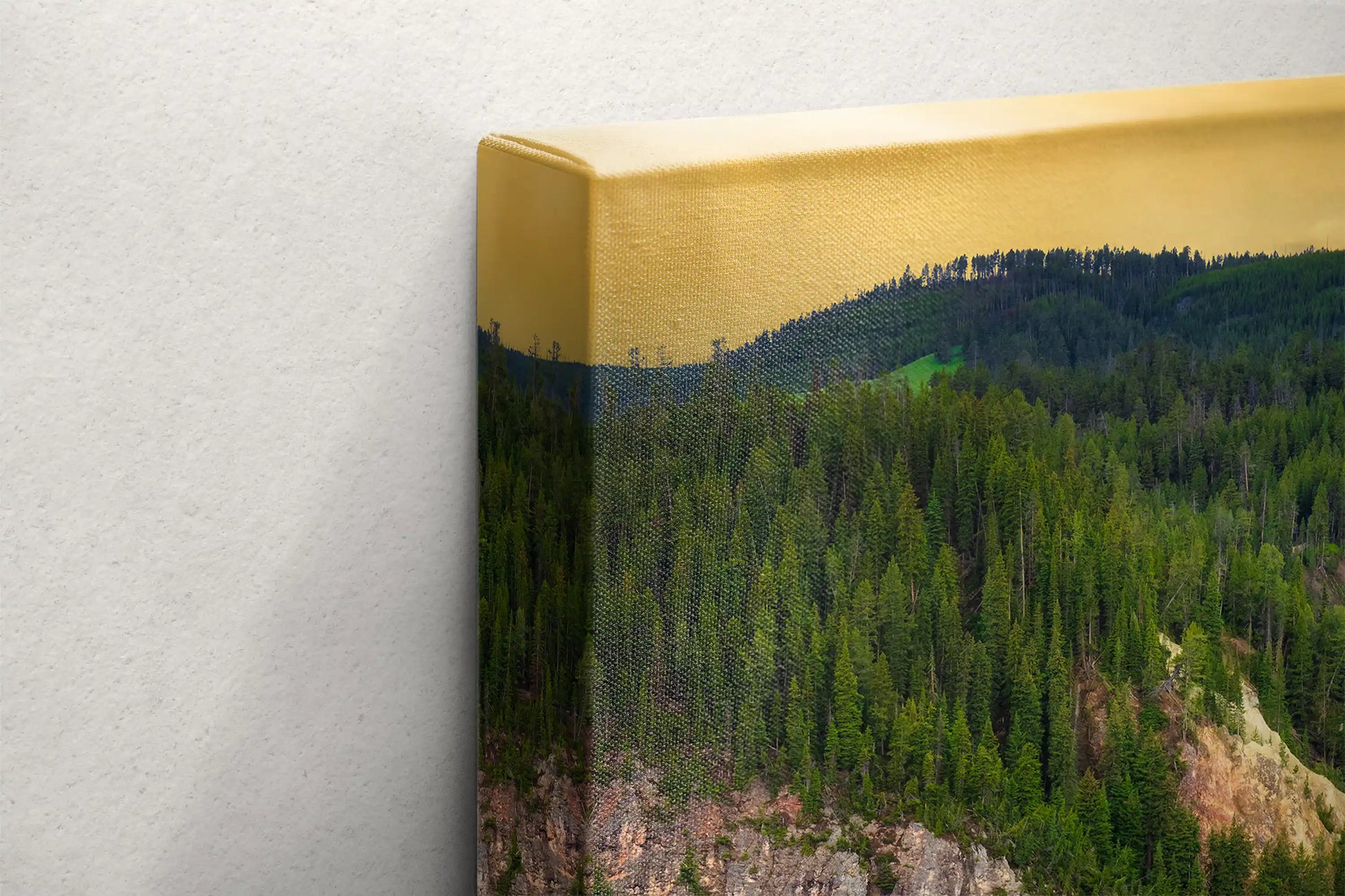 Edge view of a canvas print featuring the golden-hued top border that complements the verdant forest of Lower Yellowstone Falls, capturing the vibrant essence of Yellowstone.