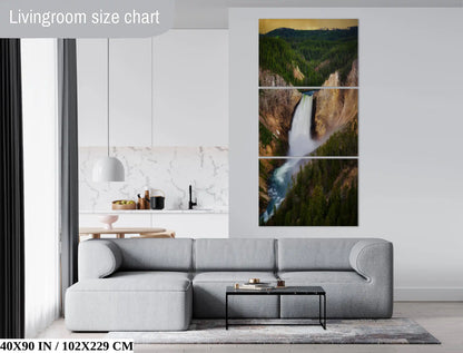 Wall-sized 40x90 inch canvas print of Lower Yellowstone Falls at sunset in a living room, providing a breathtaking natural panorama.