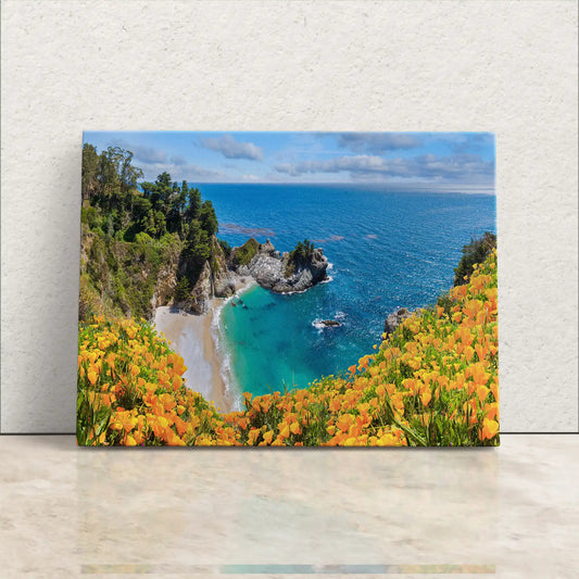 Front-facing canvas wall art showcasing the picturesque McWay Falls at Big Sur, surrounded by blooming yellow wildflowers.