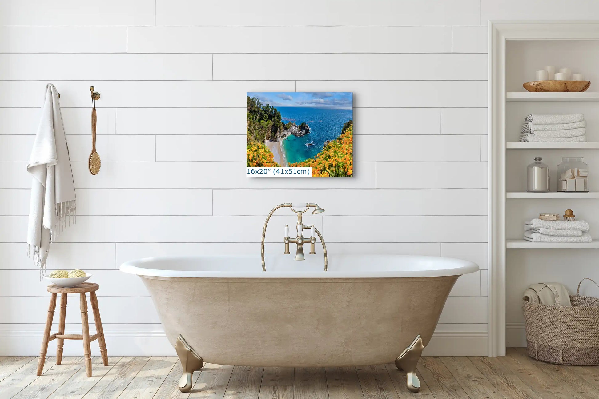 A 16x20 canvas wall art of McWay Falls at Big Sur placed above a bathtub, complementing the bathroom ambiance.