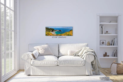 A 12x36 canvas wall art of McWay Falls at Big Sur displayed over a couch in a living room setting, blending with the interior.