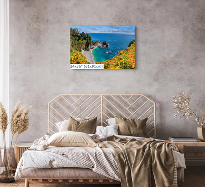 A 24x36 canvas wall art of McWay Falls at Big Sur in a bedroom, creating a tranquil focal point above the bed.