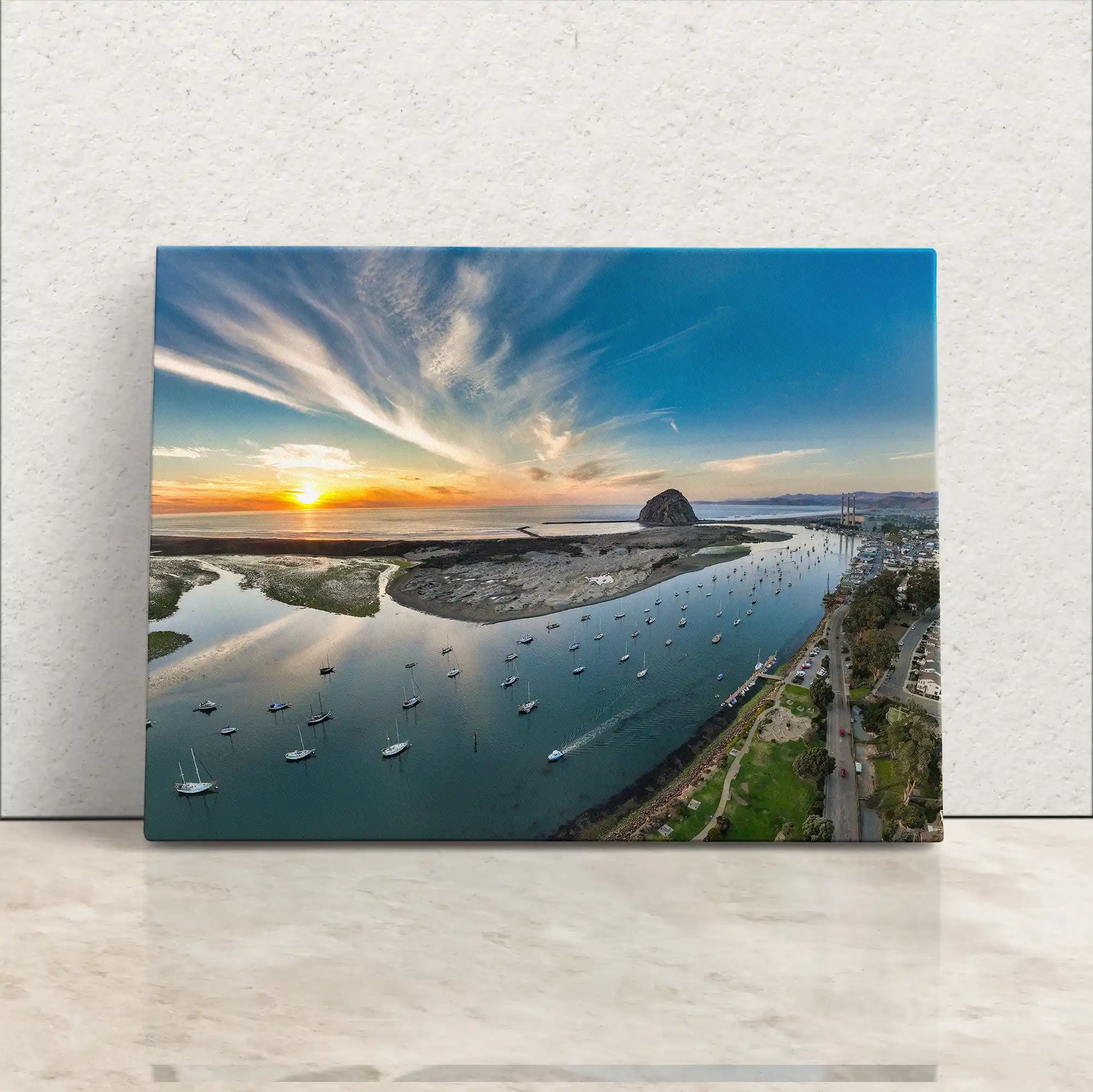 Canvas art capturing the sunset over Morro Bay, with Morro Rock and anchored boats reflecting the serene California coastal vibe.
