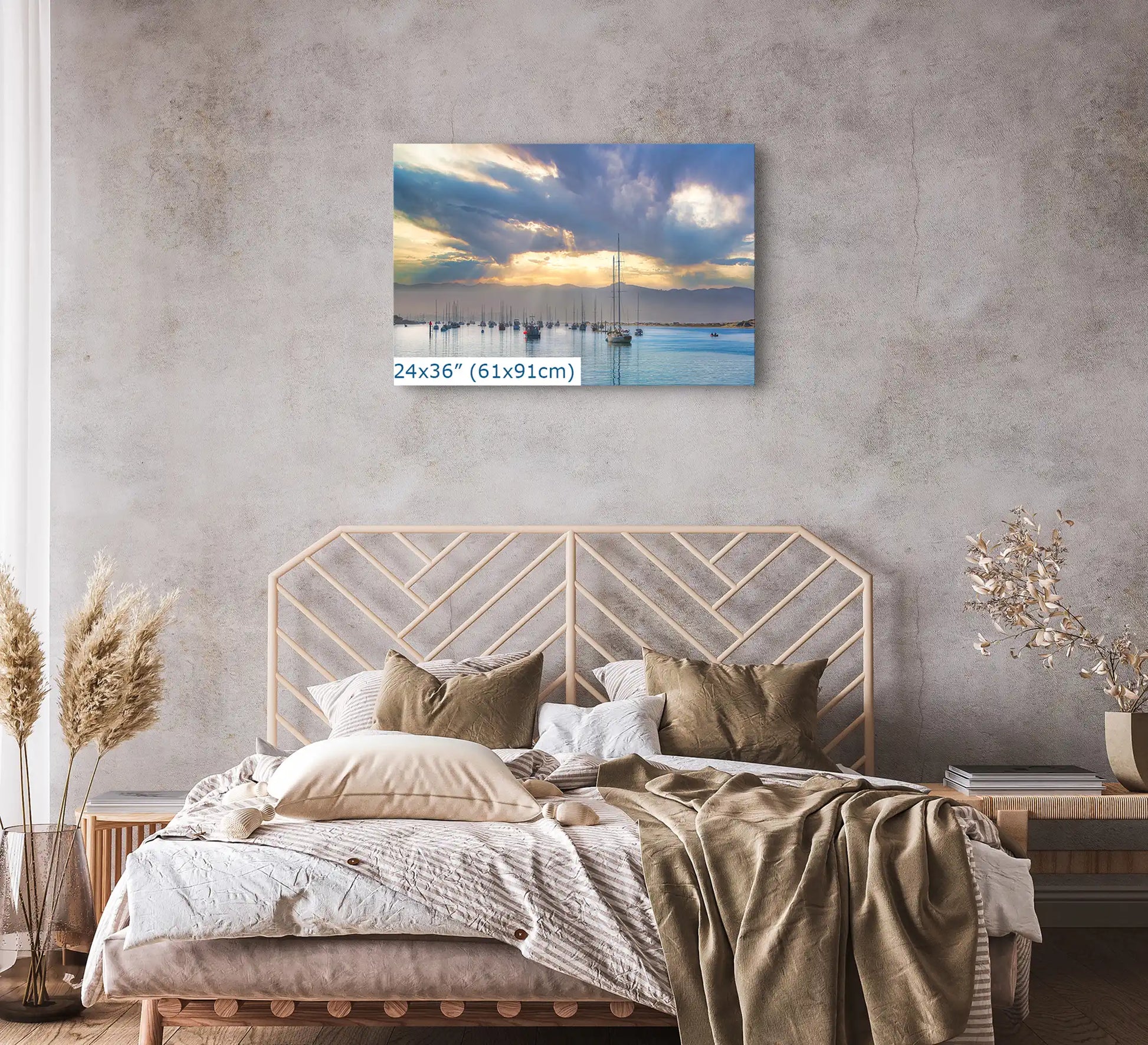 A 24x36 inch canvas print adorns a bedroom wall, showcasing a harbor view with reflective water and a soft sunrise.