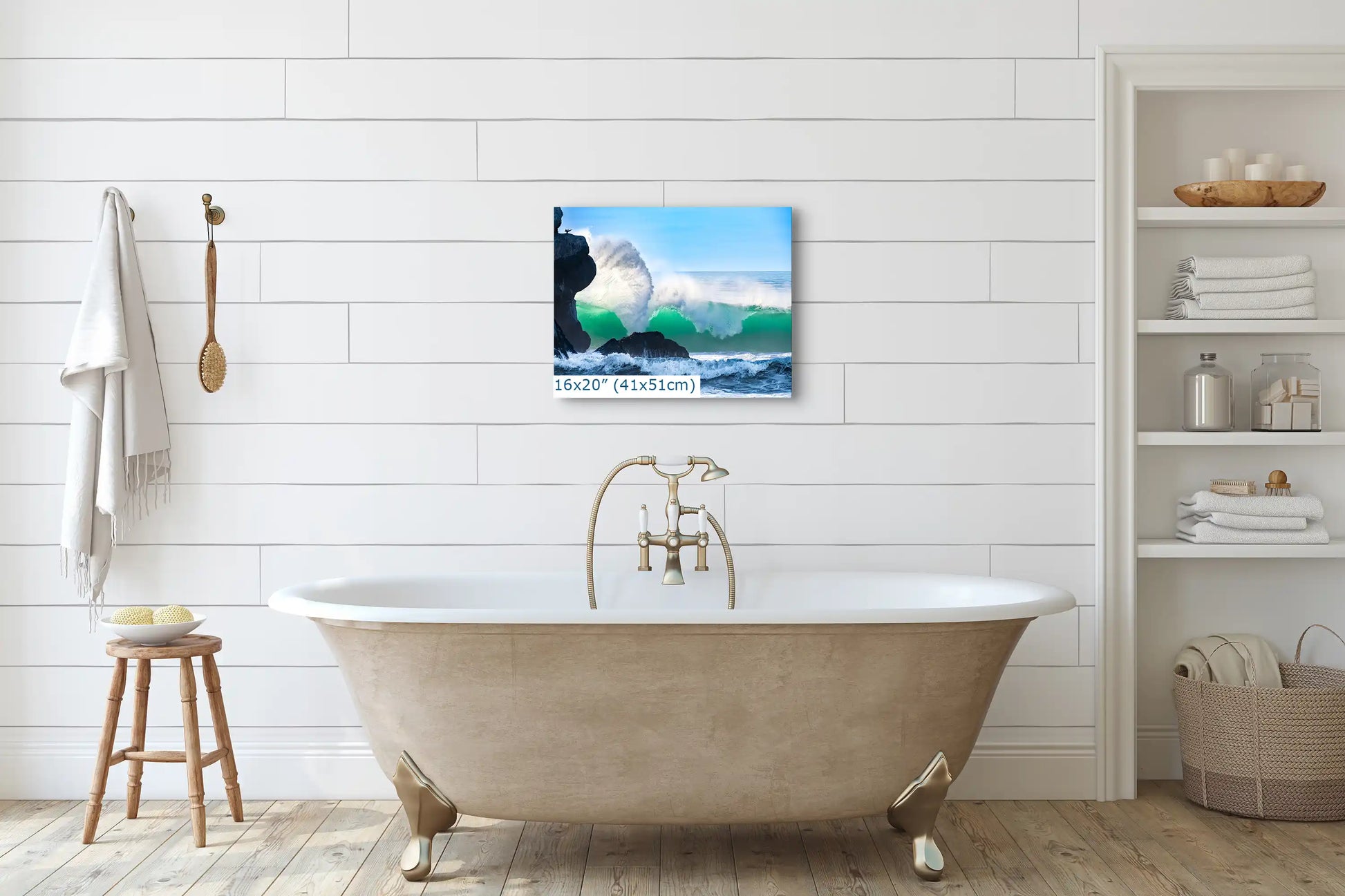 A 16"x20" print of a cresting wave near Morro Rock, hanging above a vintage bathtub, complementing the bathroom's tranquility.