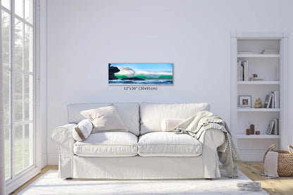 A panoramic 12"x36" wall art featuring a towering wave by Morro Rock, accentuating the living room's airy and bright ambiance.