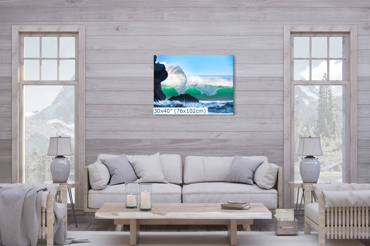 A large 30"x40" canvas print of an ocean wave crashing near Morro Rock, creating a serene backdrop in a cozy living room setting.