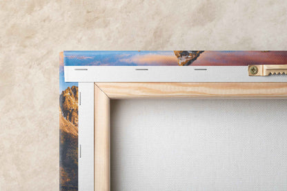 Close-up of the back of a canvas print showing the John Moulton Homestead with the Teton Mountains at sunrise, highlighting the texture and wooden stretcher bars.