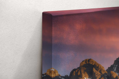 Corner view of a canvas wall art depicting the John Moulton Homestead against the Teton Mountains, highlighting the rich colors of sunrise at Grand Teton National Park.