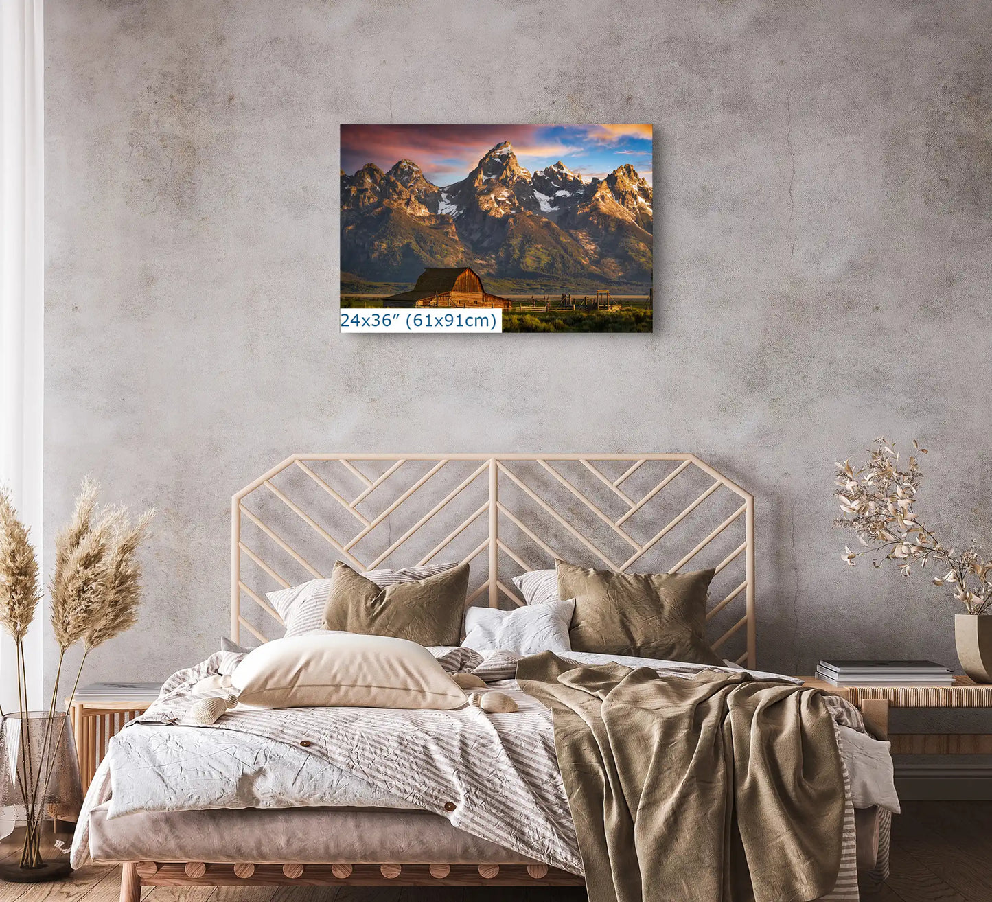 A 24x36 canvas print above a bed, capturing the sunrise over the John Moulton Homestead with the Teton Mountains, adding a peaceful touch to the bedroom decor.