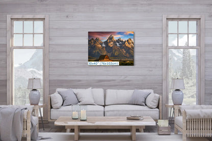 A large 30x40 canvas wall art placed above a sofa, featuring the John Moulton Homestead and Teton Mountains at sunrise, serving as a focal point in the living room.