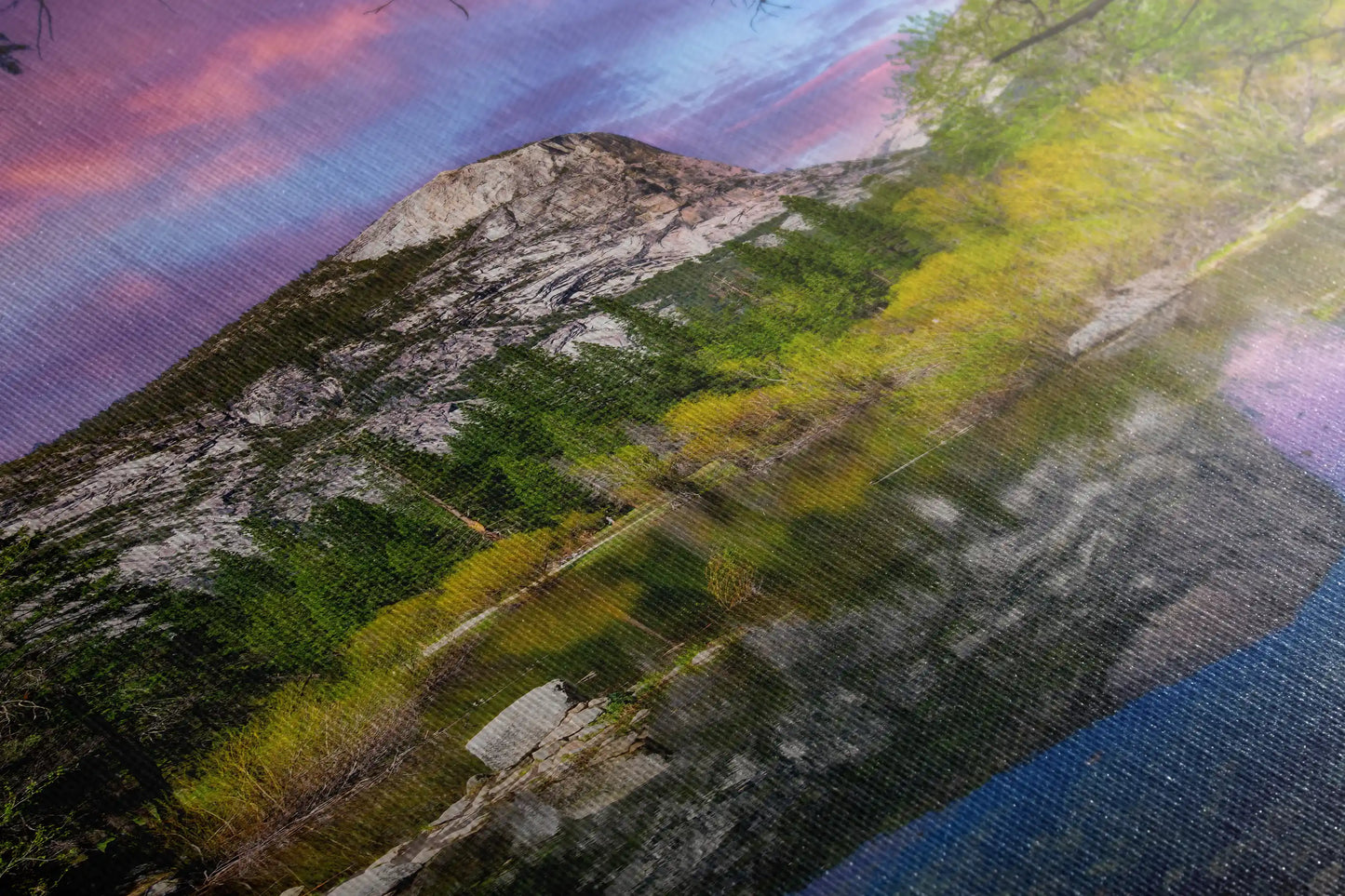 Close-up of a canvas print showing the reflective waters of Mirror Lake and the imposing Mt. Watkins at Yosemite during sunset.