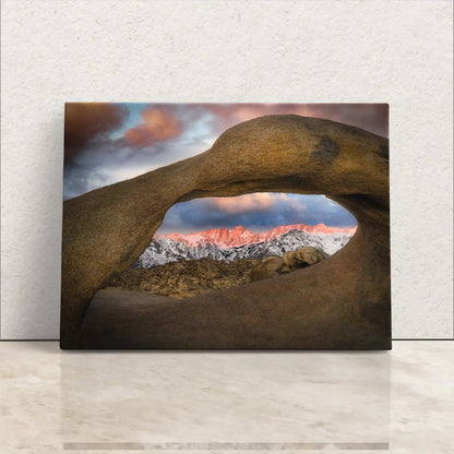 Canvas wall art of Mount Whitney seen through Mobius Arch at sunrise, warm hues illuminating the Sierra Nevadas, symbolizing serenity.