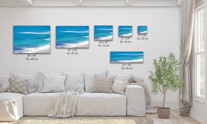 Blue Ocean abstract art available in multiple sizes shown over a living room couch