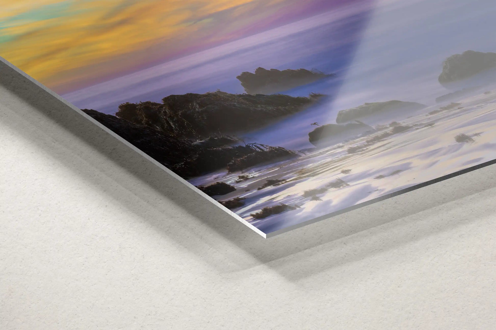 Detailed corner view of a metal print, highlighting the majestic sunset at Purple Sand Beach in Big Sur with a contemporary edge.