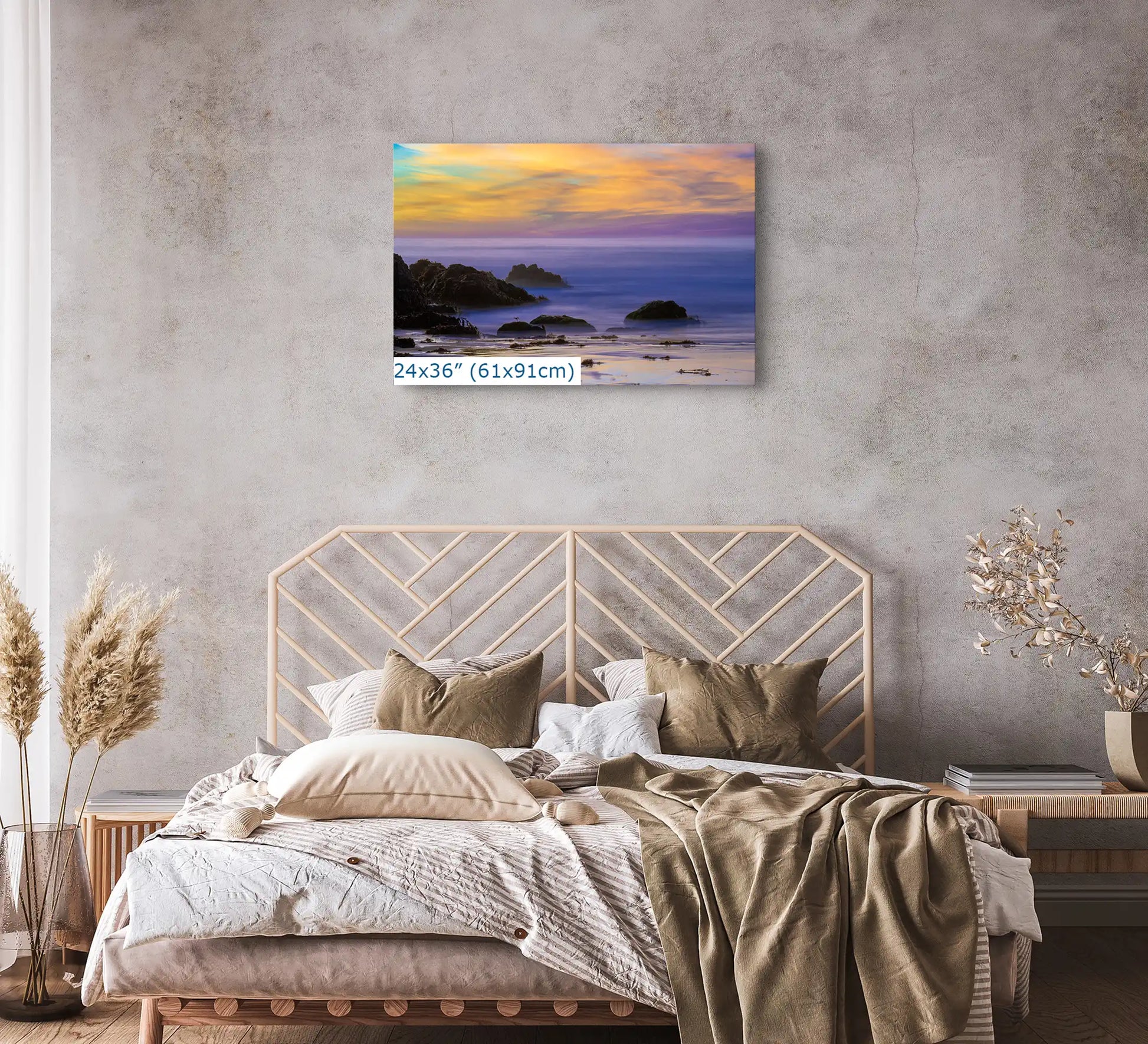 A 24x36 canvas above a bed, featuring the tranquil sunset at Purple Sand Beach in Big Sur, inviting peaceful contemplation and rest.