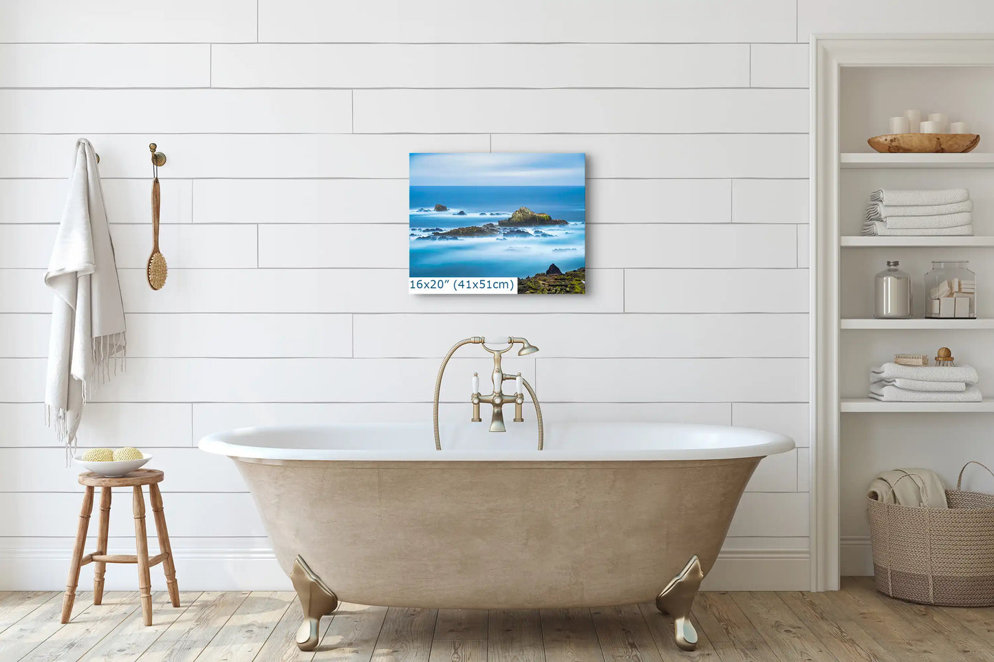 A 16"x20" canvas of Point Lobos seascape adorning a white bathroom wall, enhancing the tranquil bath setting.