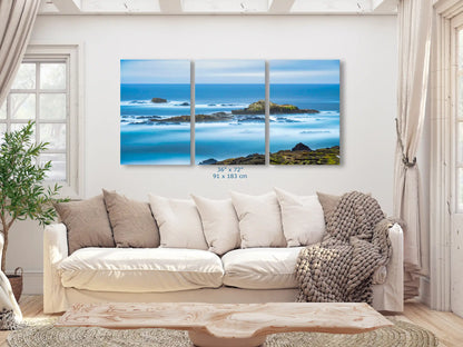 A split canvas triptych of Point Lobos seascape, spanning 36"x72", transforming a living room with expansive ocean views.