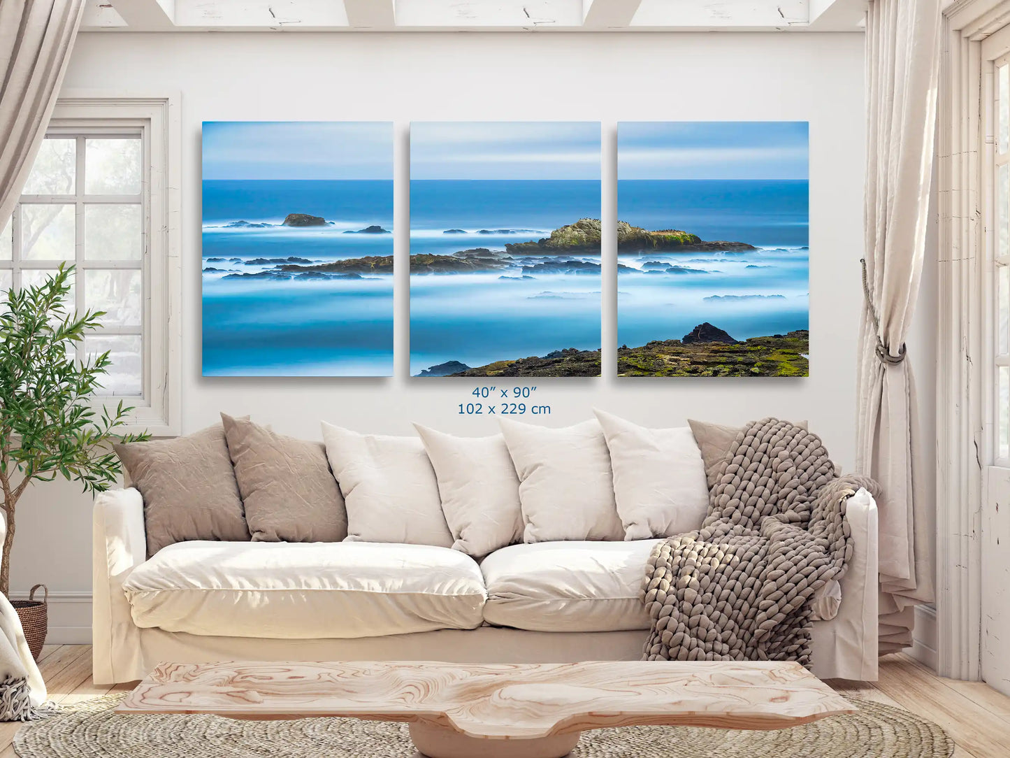 An impressive 40"x90" Point Lobos seascape, spread across four panels, offering a panoramic ocean experience in a living room.