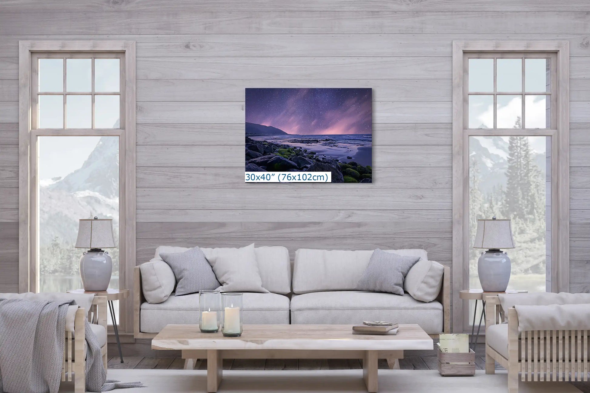 A 30x40 inch wall art featuring a beach at night under a starry sky, hung in a living room setting.