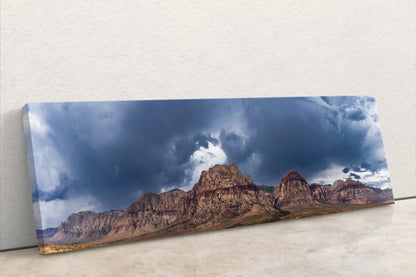 Full front view of a panoramic Red Rock Canyon canvas print, leaning against a white wall, emphasizing the wide and immersive landscape.