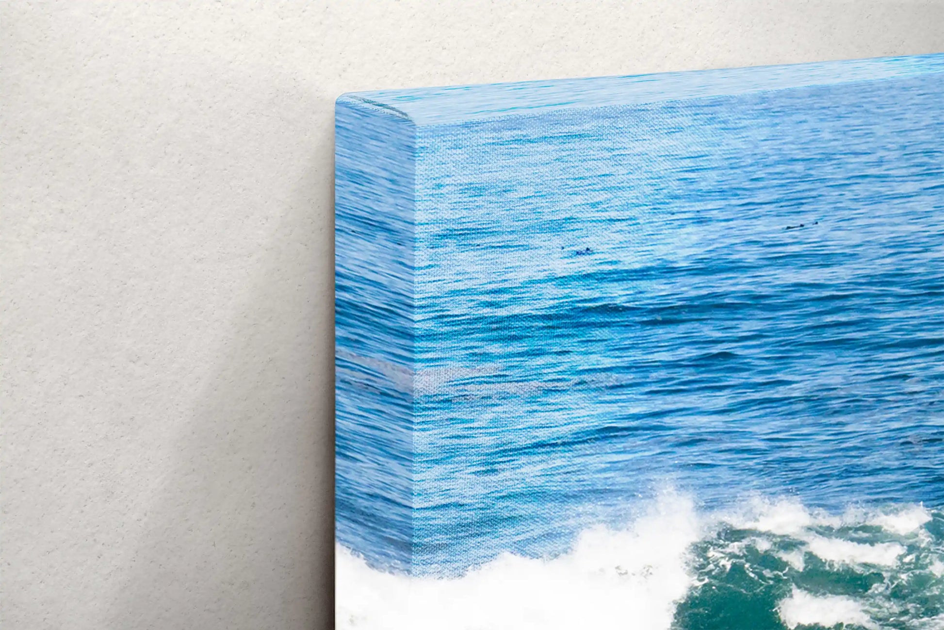 Detail shot of the back of the ocean scene canvas, showing the solid frame and mounting hardware.