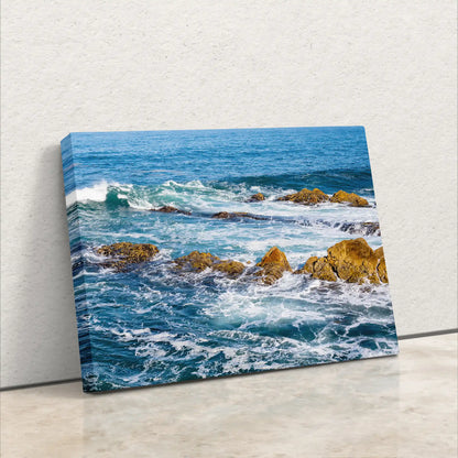 Close-up of the canvas texture of the ocean scene print, highlighting the detail and color depth of the waves and rocks.
