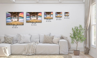 A variety of canvas sizes of Balboa Pier at sunset, displayed above a sofa for scale, showing options for home decor.