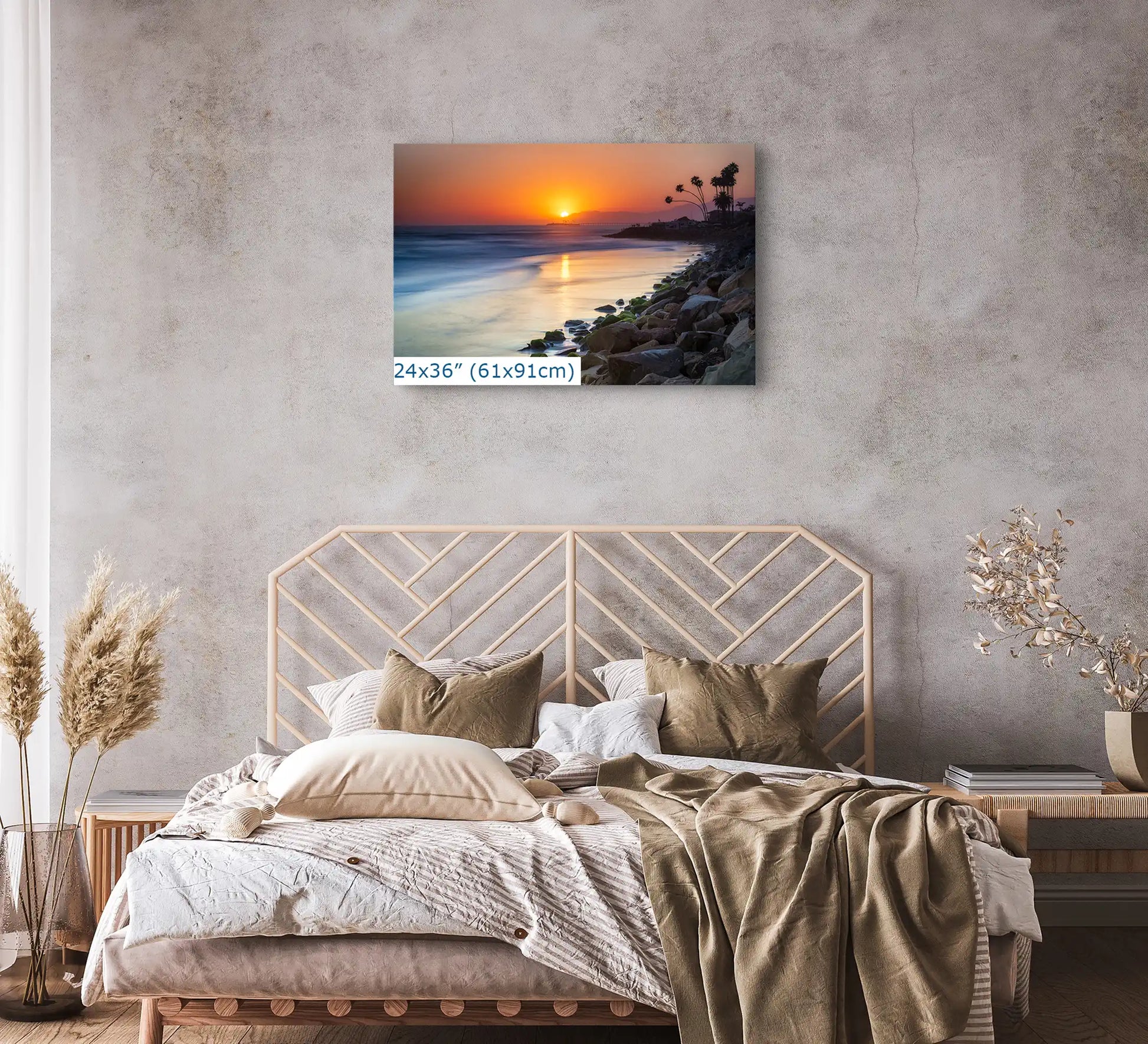 A 24"x36" canvas print of Ventura Beach sunset above a bed, transforming the bedroom into a peaceful retreat.